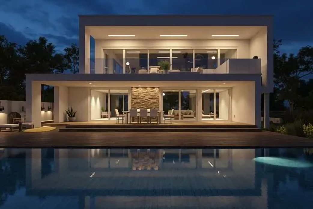 Vivienda contemporánea con piscina e iluminación cálida al anochecer